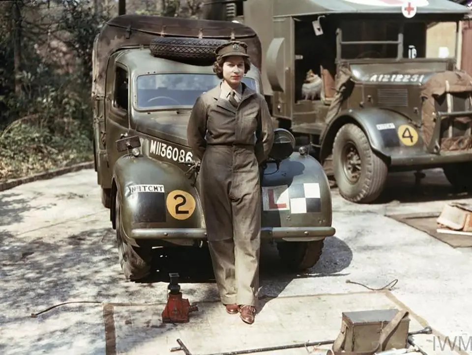 Auxiliary Territorial Service: Princess Elizabeth, a 2nd Subaltern in the ATS, wearing overalls and standing in front of an L-plated truck. In the background is a medical lorry. Copyright: © IWM. Original Source: http://www.iwm.org.uk/collections/item/object/205194945
